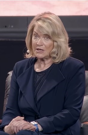 A woman with shoulder-length blonde hair 