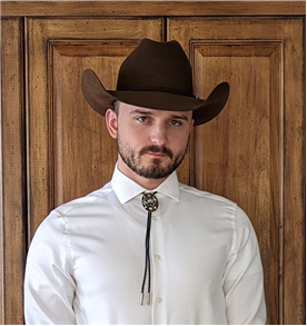 A man wearing a brown cow boy hat