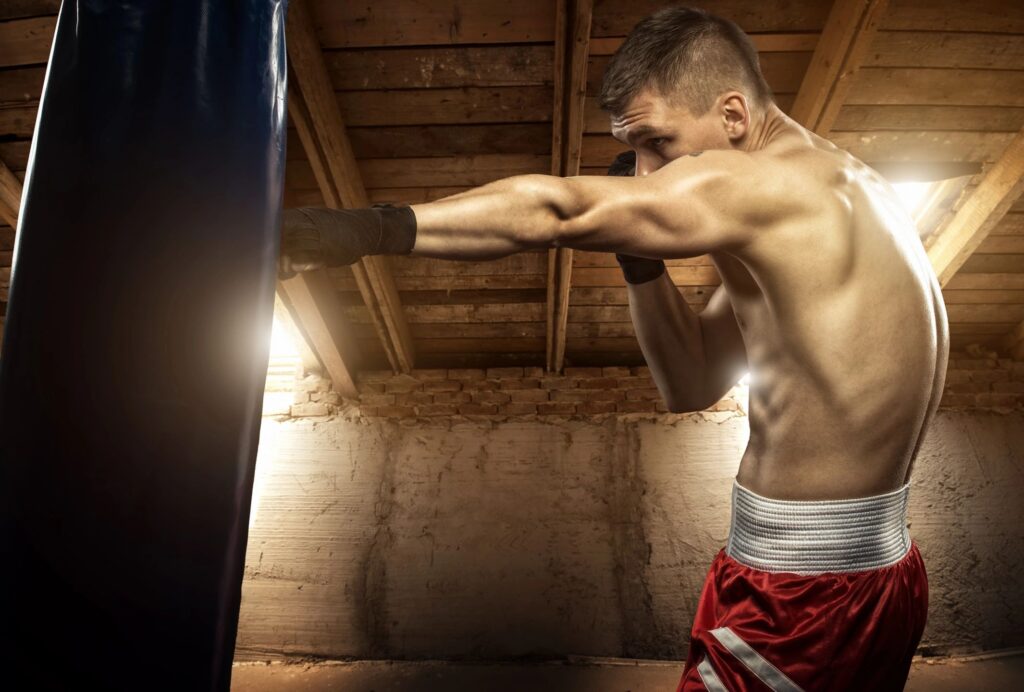 Boxer Practicing with Punching Bag