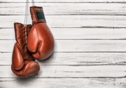 Boxing Glover Hanging Over Wooden Plank